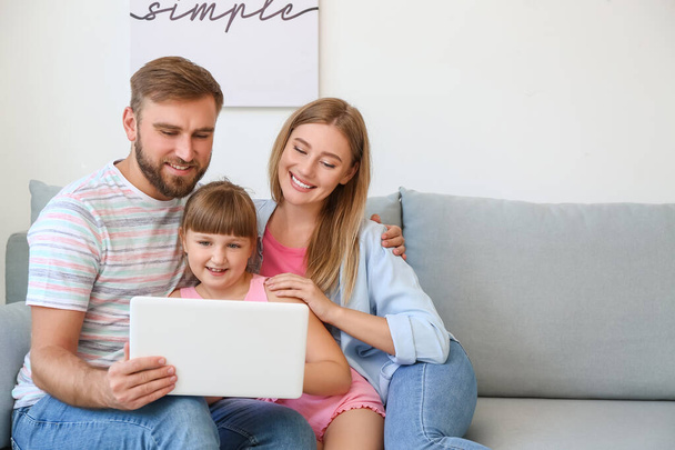 Happy family with laptop at home - Photo, Image