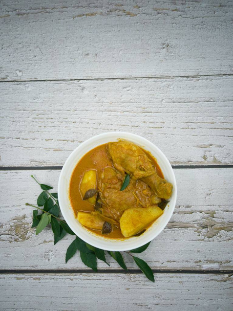 A serving of chicken curry with potatoes. Selective focus points. Blurred background - Photo, Image