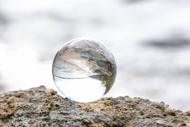 Crystal ball of fortune teller outdoors near river - Фото, изображение