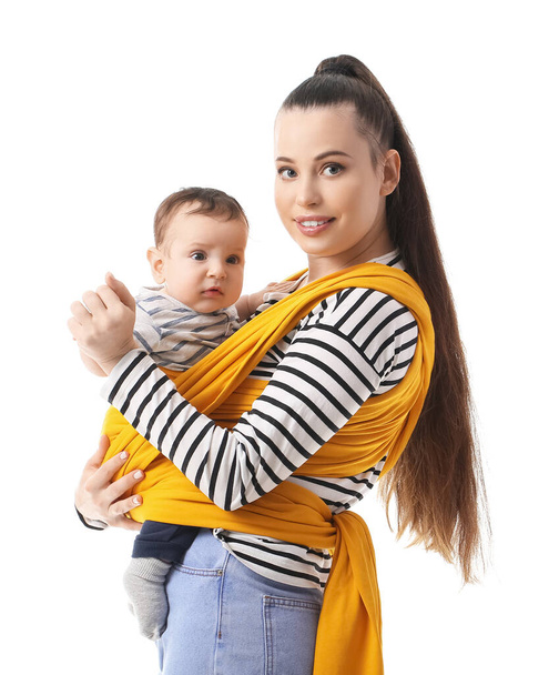 Young mother with little baby in sling on white background - Foto, afbeelding