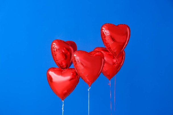 Heart shaped air balloons on color background - Photo, Image