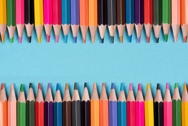 Color pencils array  on blue background - Photo, Image