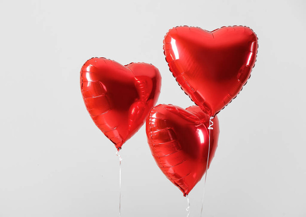 Heart shaped air balloons on grey background - Фото, зображення