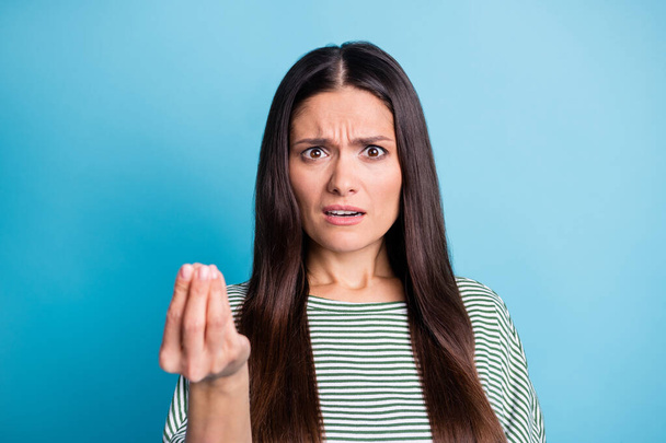 Photo of unsatisfied lady sullen face show hand fingers few wear white green isolated on blue color background - Foto, afbeelding