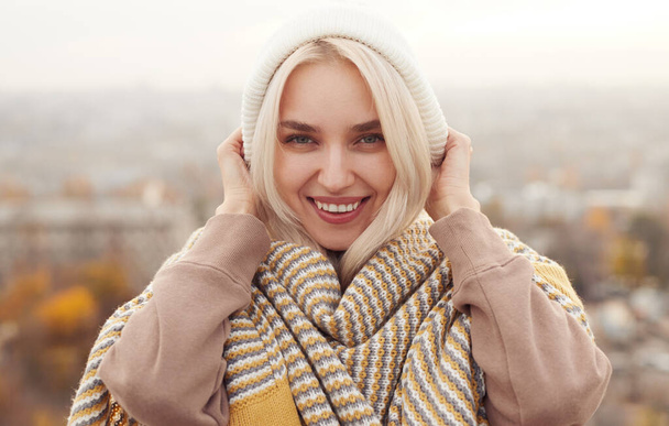 Smiling young woman in stylish warm outfit - Фото, изображение