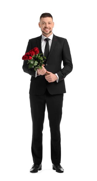 Handsome man with bouquet of beautiful flowers on white background - Zdjęcie, obraz