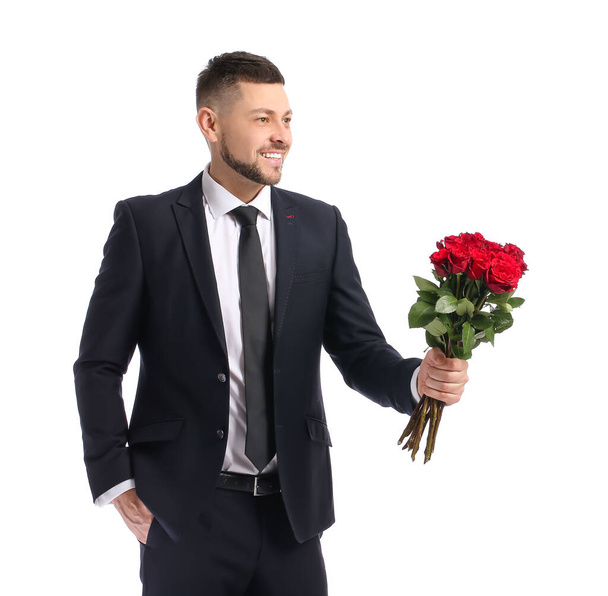 Handsome man with bouquet of beautiful flowers on white background - Foto, Imagem