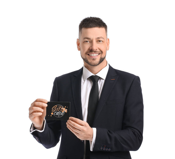 Handsome man with gift card on white background - Foto, Imagem