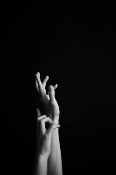 details of the body, hands on black background close-up - Fotografie, Obrázek