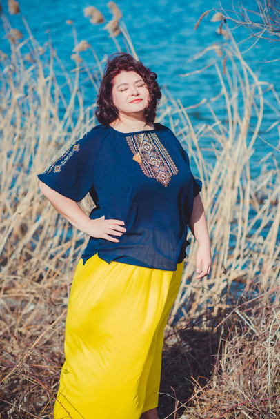 Middle age plus size woman enjoying the life. A mature lady with excess weight, stylishly dressed. Natural beauty - Photo, Image