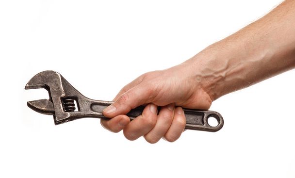 Регульований гайковий ключ в руках людини на білому тлі ізольований і крупним планом
 - Фото, зображення