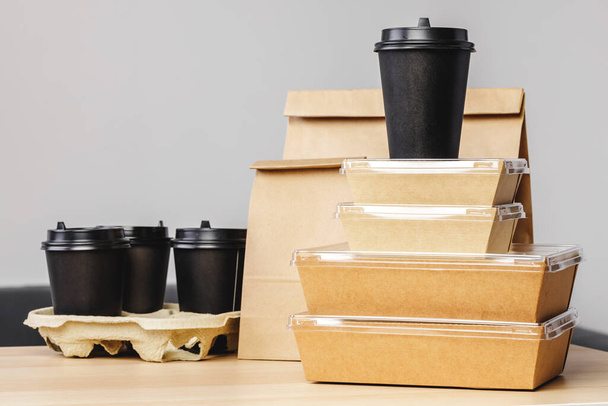 Many various take-out food containers, pizza box, coffee cups and paper bags on light grey background - Photo, Image