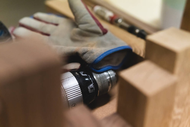 Woodworkers work space with gloves and screwdriver. - Photo, Image