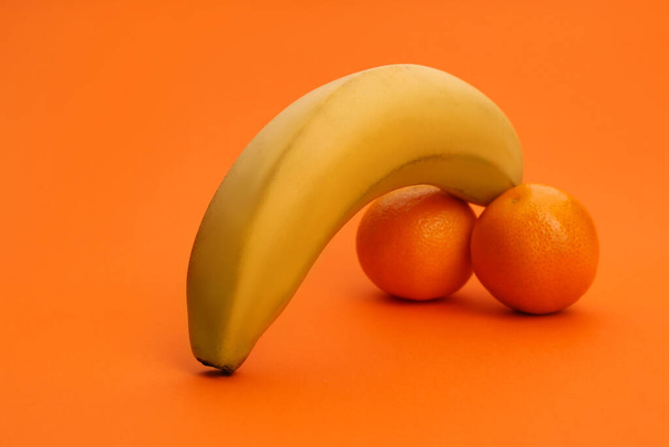 Fruits symbolizing male sexual organ on orange background. Potency problem - Foto, Imagen