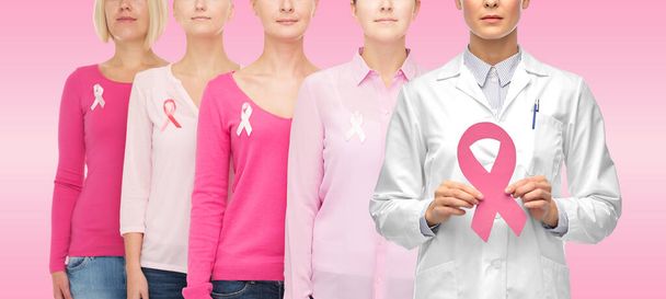 doctor and women with cancer awareness ribbons - Foto, imagen