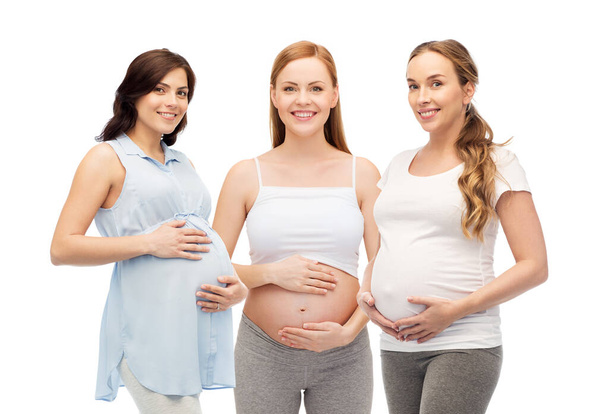happy pregnant women touching their big bellies - Фото, зображення