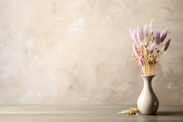 Dried flowers in vase on table against light grey background. Space for text - Foto, Imagem