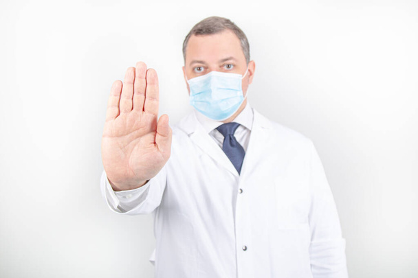 Doctor in white robe and mask with stethoscope with different gestures  - Foto, Imagem