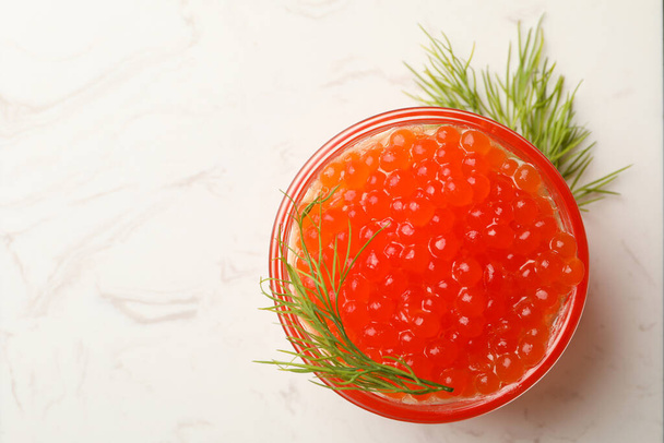 Glass bowl with red caviar and dill, space for text - Photo, image