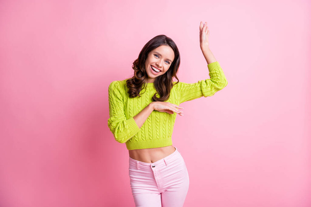 Photo of funny carefree young girl dance raise palms beaming smile wear green sweater isolated pink color background - Fotoğraf, Görsel