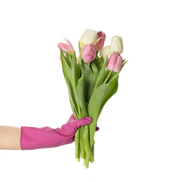 Female hand in housework gloves hold tulips, isolated on white background - Photo, Image