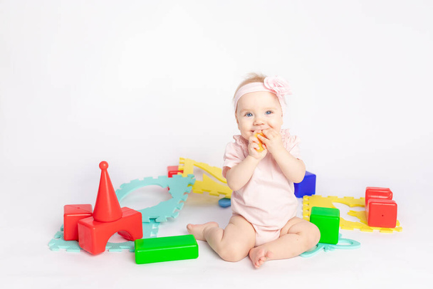 the kid plays with cubes on a white isolated background, space for text - Fotografie, Obrázek