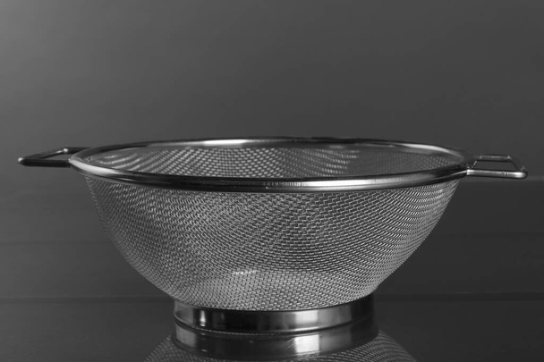 Empty strainer metal with handle blurred background. Front view - Photo, Image