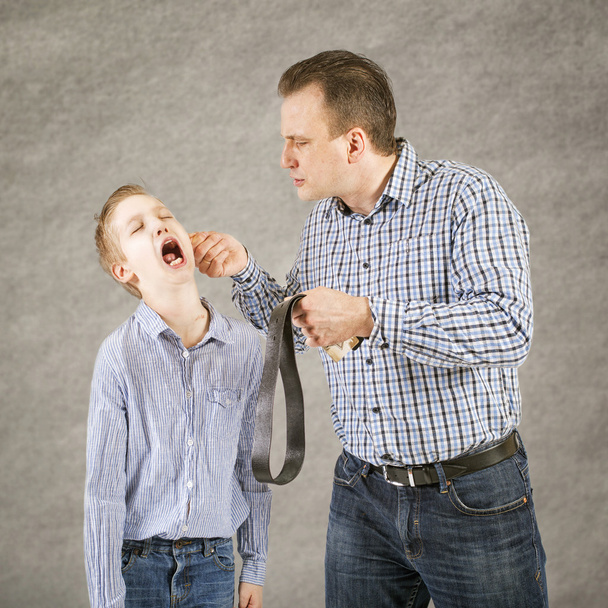 Father punishes son. - Foto, afbeelding