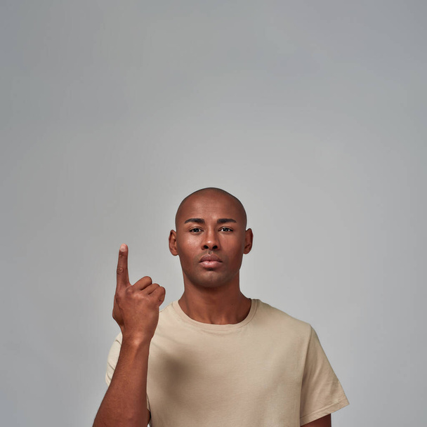 Multiracial man is pointing a finger up - Fotó, kép