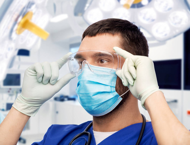male doctor in goggles, mask and gloves - Photo, Image