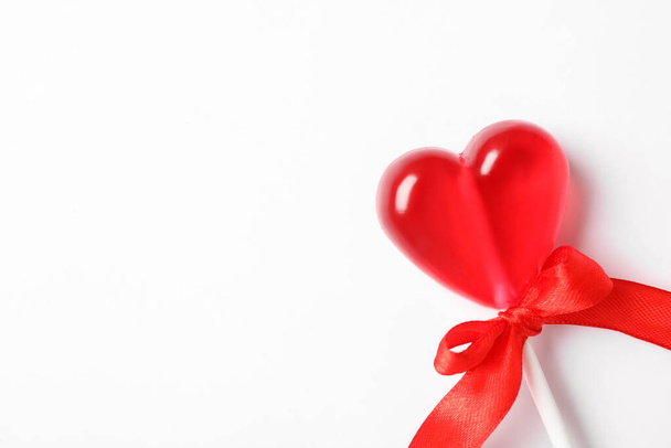 Sweet heart shaped lollipop on white background, top view with space for text. Valentine's day celebration - Fotoğraf, Görsel