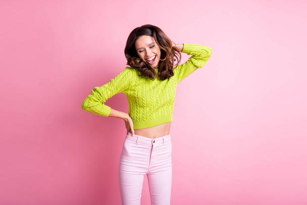 Photo of shiny adorable wavy lady wear green sweater smiling dancing isolated pastel pink color background - 写真・画像
