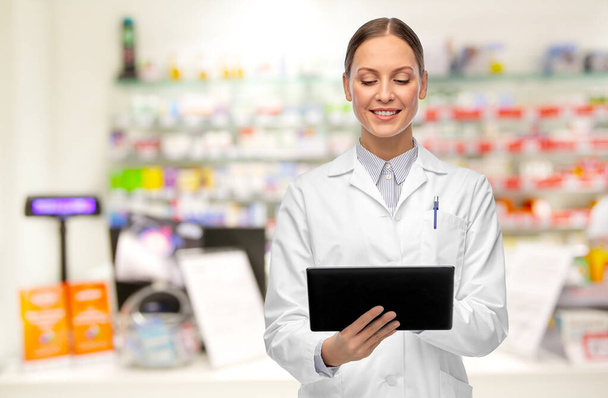female doctor with tablet pc at pharmacy - Foto, Imagem