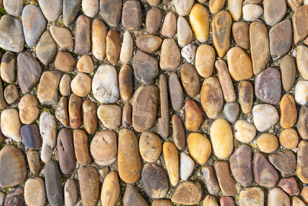Κοντινό πλάνο ενός εξωτερικού λιθόστρωτου. Πέτρα και αφηρημένο υπόβαθρο - Φωτογραφία, εικόνα