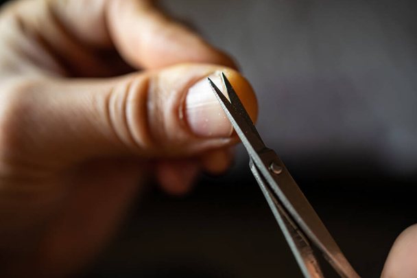 Cut Your Nails. A Young Man Cuts His Nails With Nail Scissors. - Foto, imagen