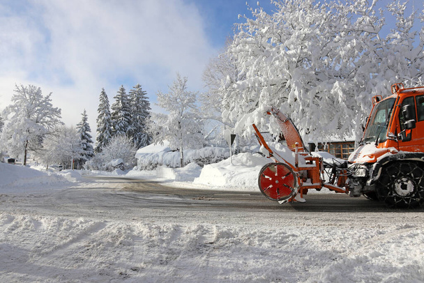 Uno spazzaneve con un spazzaneve guida per la strada in inverno per liberare l'alta neve - Foto, immagini