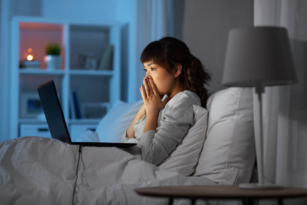 stressed woman with laptop working in bed at night - Foto, immagini