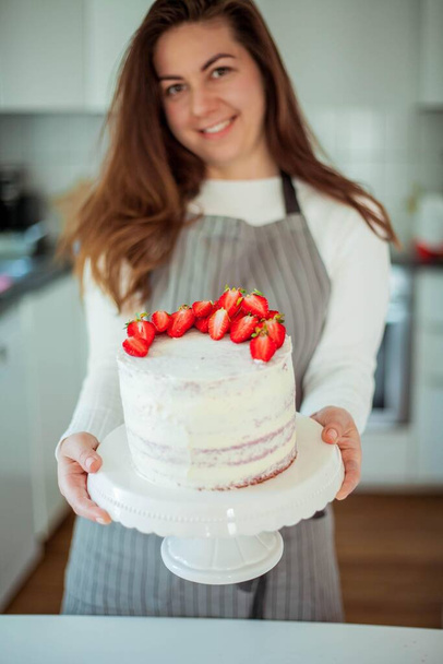 Young beautiful woman bakes a cake. Sweets. - Φωτογραφία, εικόνα