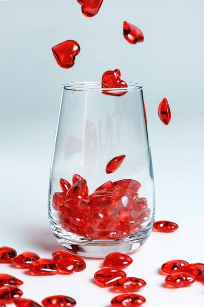 Valentine's Day. Small red glass hearts in a glass. - Φωτογραφία, εικόνα