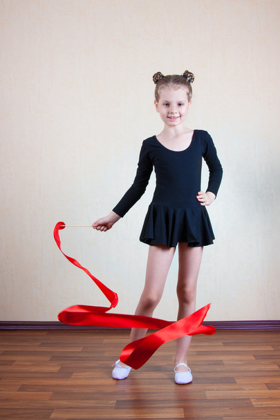 Girl gymnast with red ribbon - Foto, afbeelding