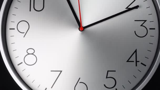 White wall clock tells the time. Rotation of the short and long hands of the clock. On the white background. - Footage, Video
