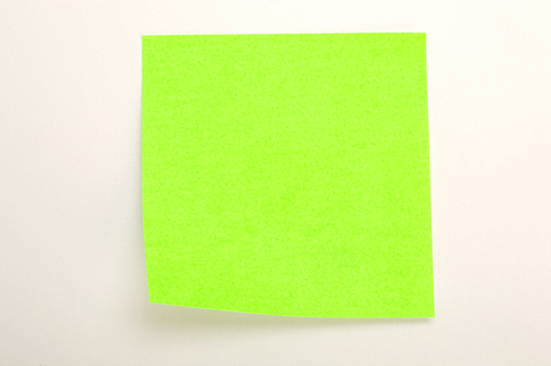 Neon green post it over white background - Фото, изображение