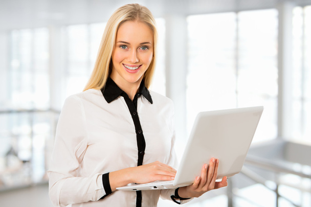 Young business woman using laptop - Фото, изображение