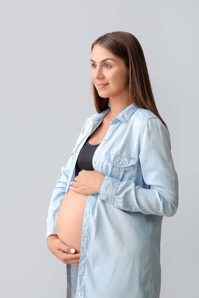 Beautiful pregnant woman on light background - Foto, Imagen