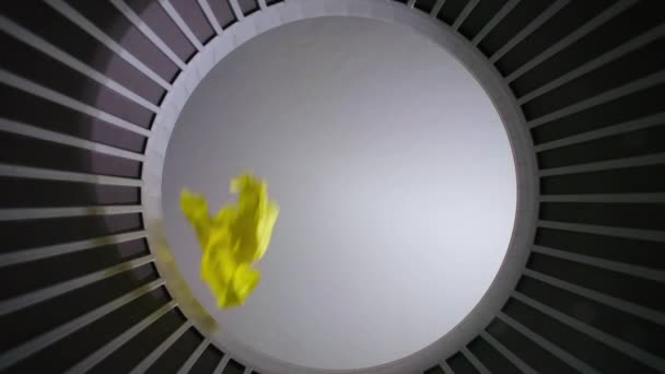 Shooting of throwed yellow crumpled papers sheet, bottom view - Footage, Video