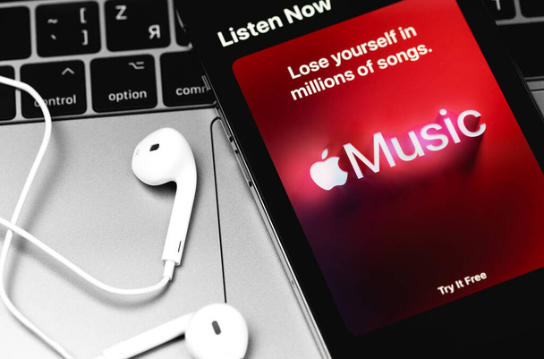 Apple Music logo mobile app on the screen iPhone with Earpods headphones. Apple Music is a music service provided by Apple. Moscow, Russia - December 5, 2020 - Photo, Image