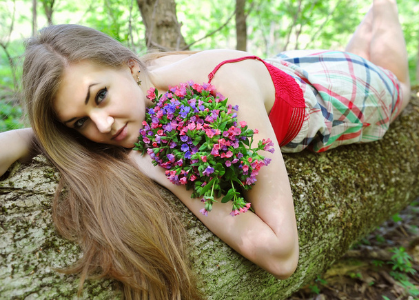 piękna młoda kobieta z bukietem wiosennych kwiatów - Zdjęcie, obraz