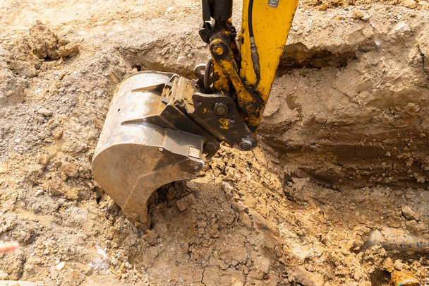 close up view of an excavator claw scoop digging a trench - Photo, Image