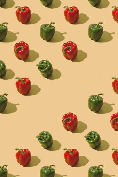 Red and green bell peppers on a pastel beige background. Creative fresh food pattern. - Foto, imagen