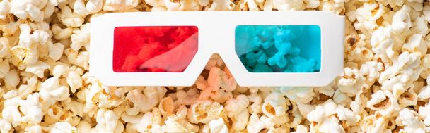 top view of 3d glasses on scattered popcorn, banner, cinema concept - Photo, Image